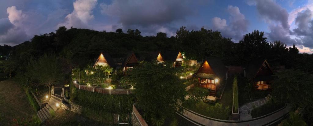 a large building with lights on it at night at Cersen Resort Lombok in Kuta Lombok