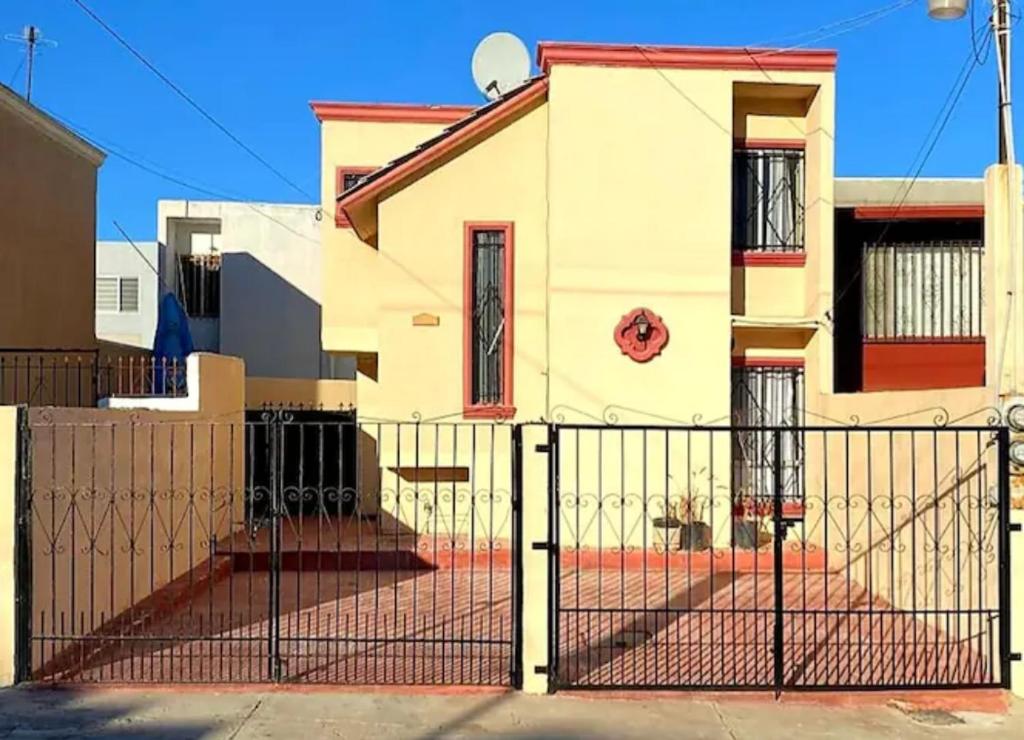 a house with a gate in front of it at COZY CASITA EN PLAYAS DE TIJUANA in Tijuana