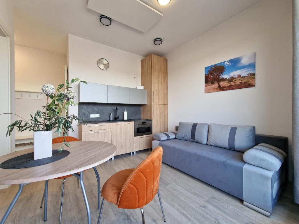 a living room with a couch and a table at MANO JŪRA 2 SILVER in Palanga