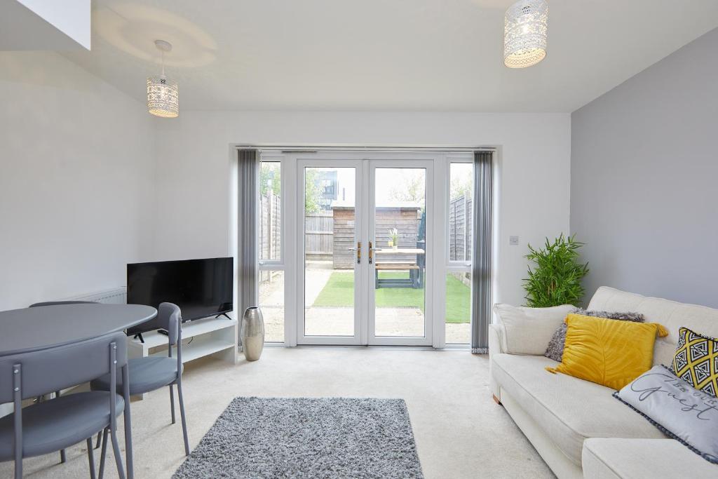 a living room with a couch and a table at Royal Derby Hospital 2 Bed Town House in Derby