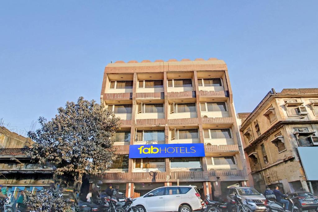 a building with a blue sign on the side of it at FabHotel Surya in Bhopal