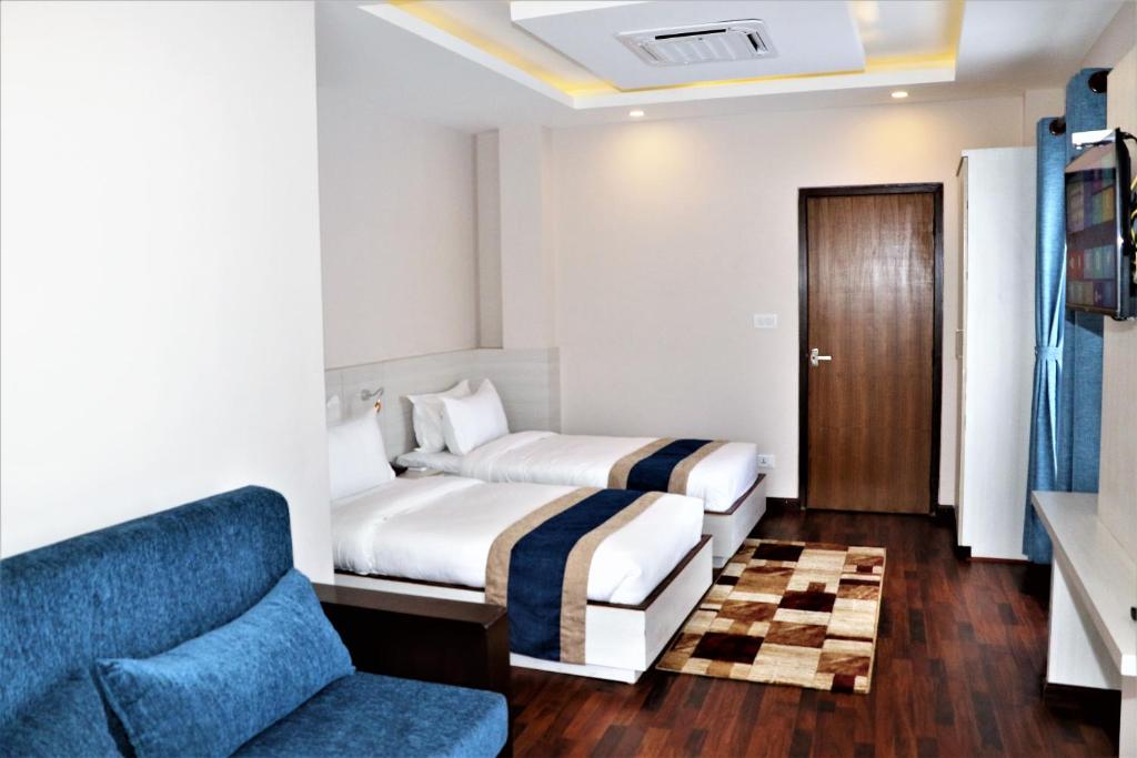 a hotel room with a bed and a couch at Hotel Mega & Apartment in Kathmandu