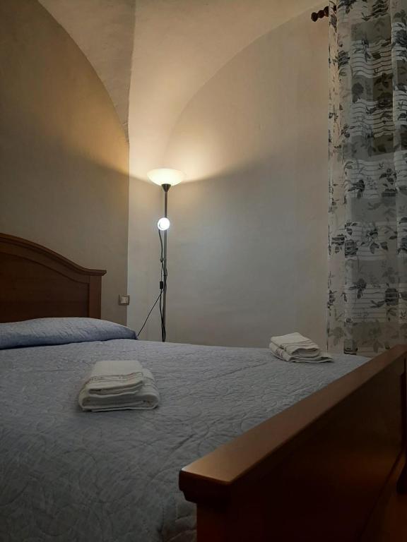 Postel nebo postele na pokoji v ubytování Alloggi Piazza Umberto Primo