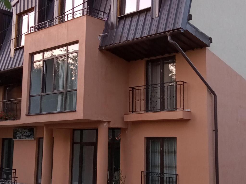 a building with balconies on the side of it at Pensiunea Valea Beiului in Socolari