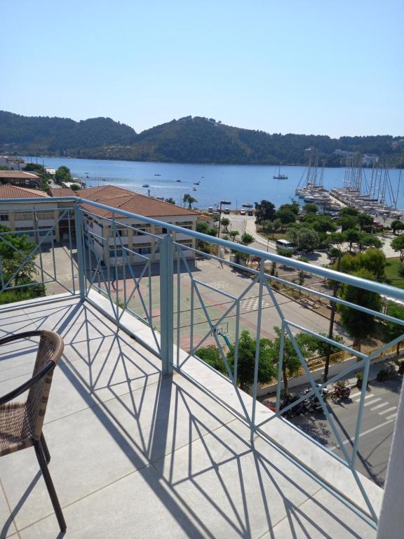 a balcony with a chair and a view of a harbor at View Port in Skiathos