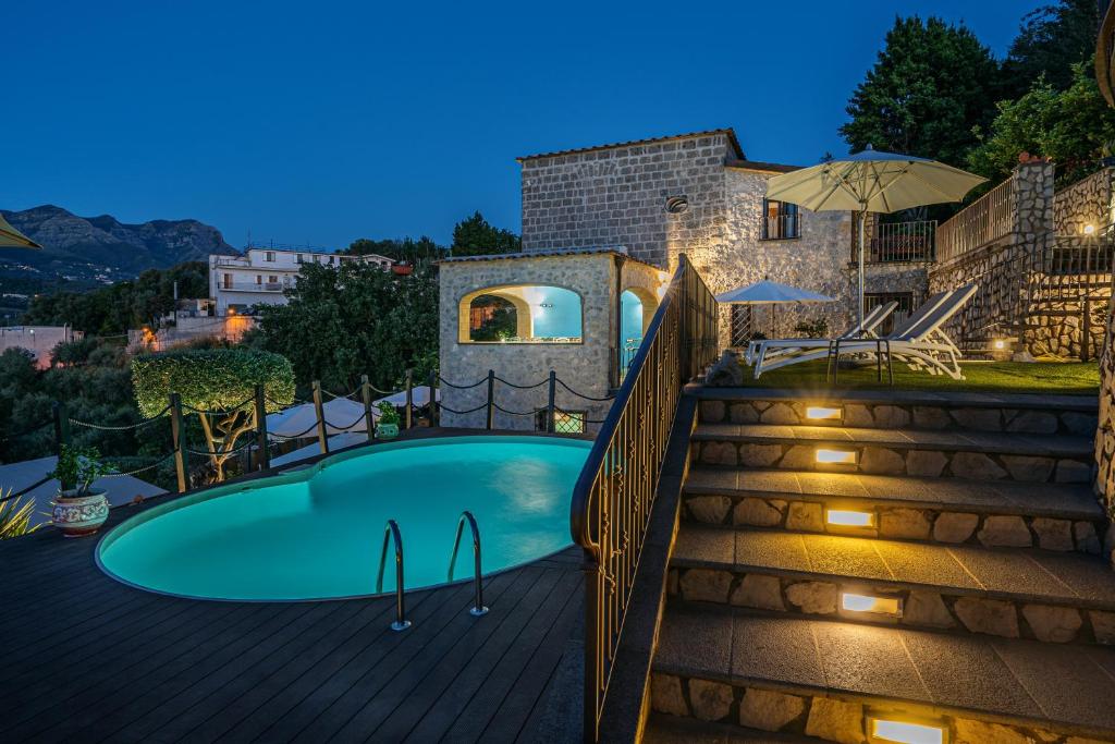 a villa with a swimming pool at night at Villa Denise in Vico Equense