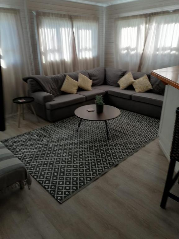 a living room with a couch and a table at Ons Strandhuisie N5 in Pearly Beach in Pearly Beach