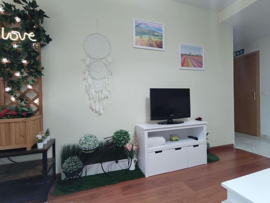 a living room with a tv on a white cabinet at Madrid AlcoTour Apto trabajo y relax in Alcobendas