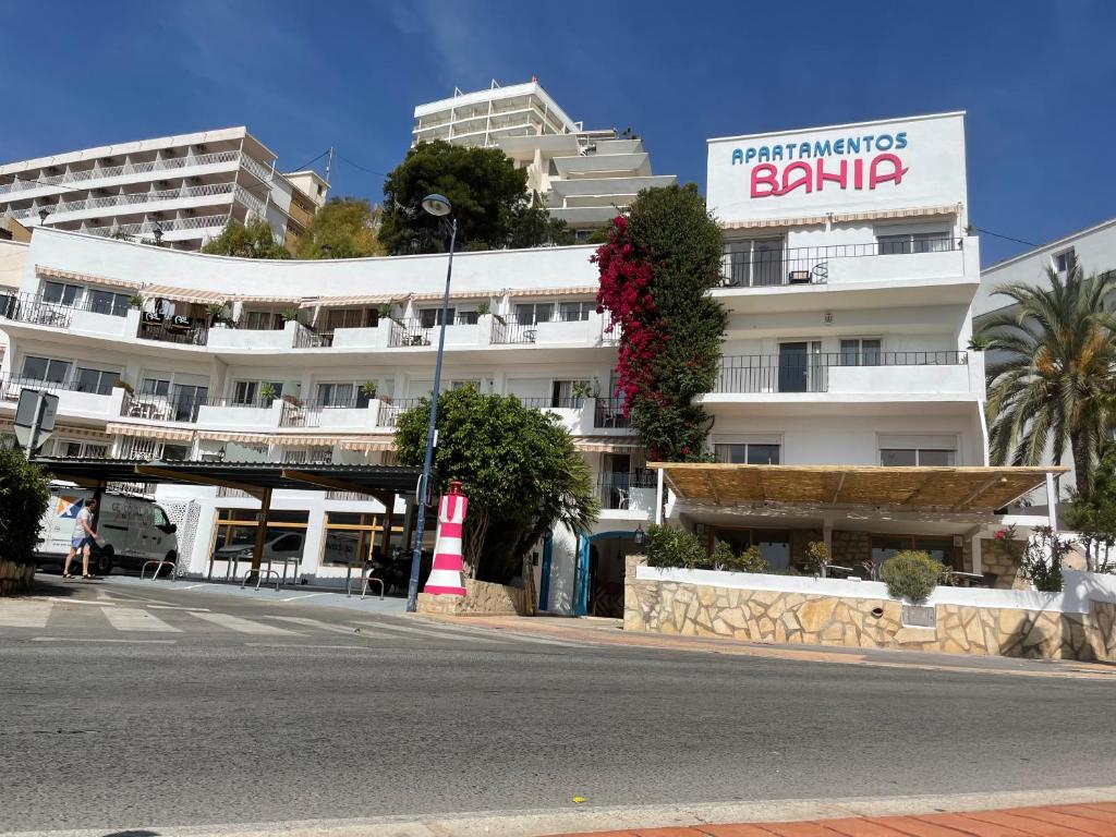 a large white building with a sign on the side of it at Apartamentos Bahia in Benidorm