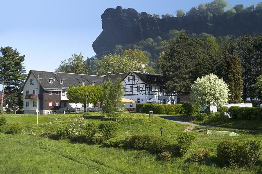 a large house with a mountain in the background at Panoramahotel Lilienstein in Königstein an der Elbe