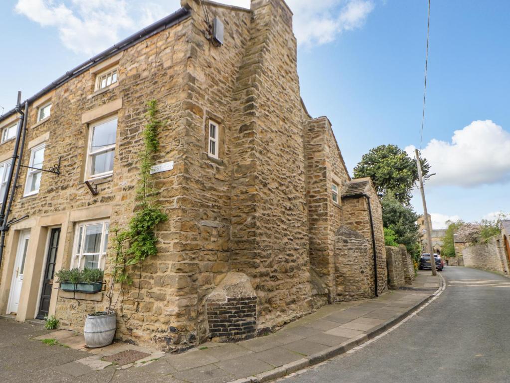 an old stone building on the side of a street at Lavender Cottage in Bishop Auckland