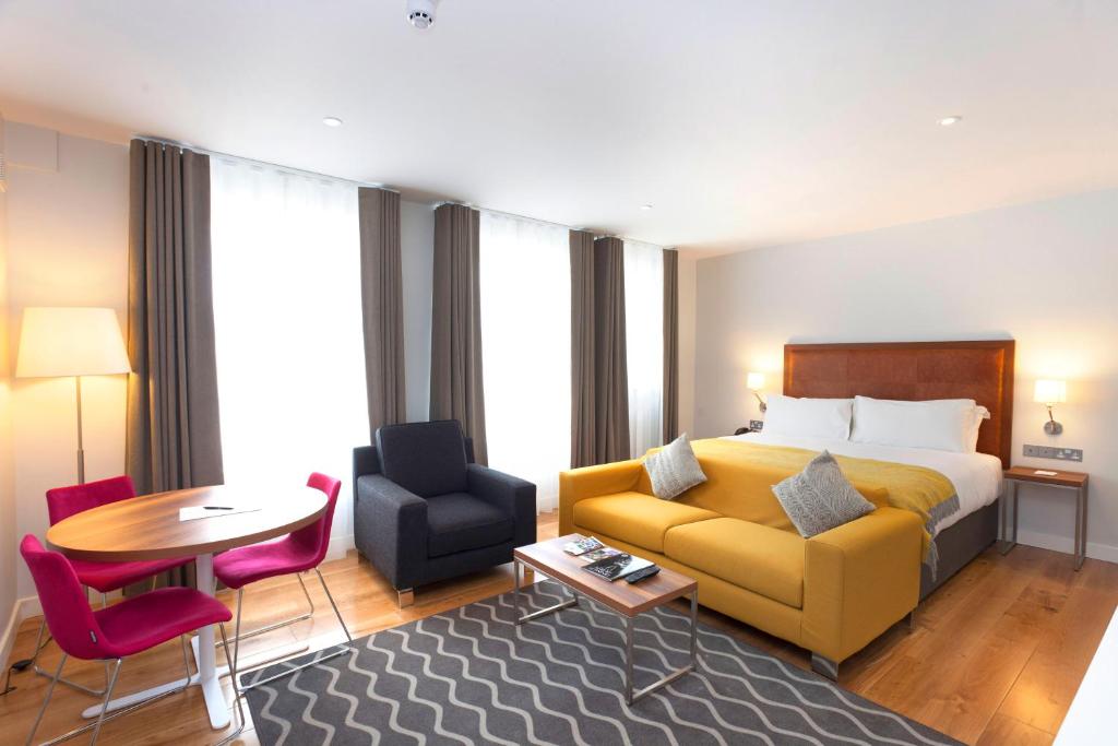 a living room filled with furniture and a couch at PREMIER SUITES PLUS Dublin, Ballsbridge in Dublin