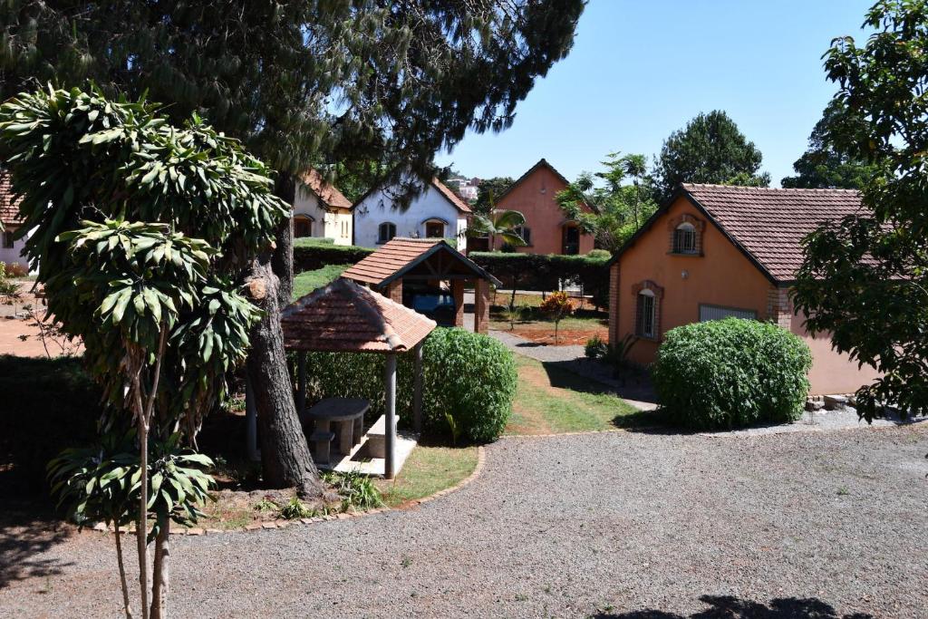 a house with a pathway in front of it at SNI-Village Ambohidratrimo au bord du Lac Andranotapahana in Ambohidratrimo