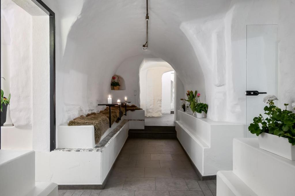 a white hallway with a bed and a table at Hotell Skeppsbron in Stockholm