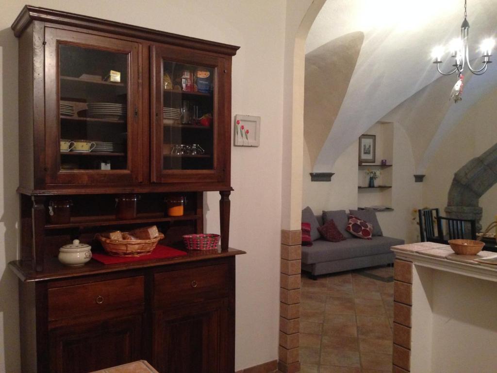 a living room with a wooden cabinet and a couch at Casa Dodo in Naples