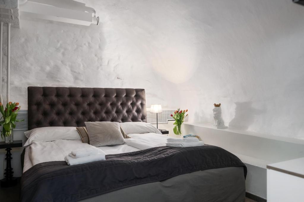 a bedroom with a large bed with a black headboard at Hotell Skeppsbron in Stockholm
