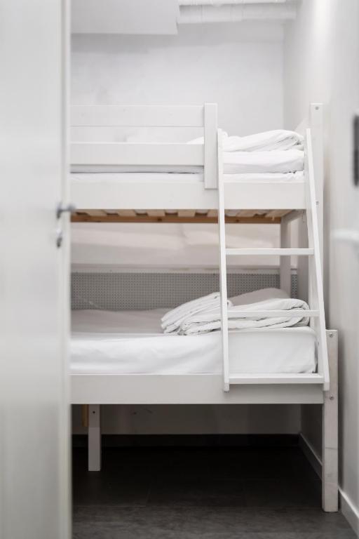 two white bunk beds in a room at Hotell Skeppsbron in Stockholm