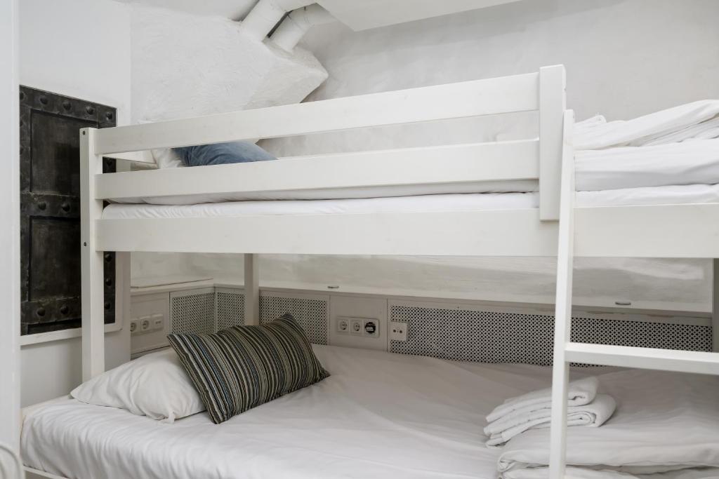 a bedroom with two bunk beds in a room at Hotell Skeppsbron in Stockholm