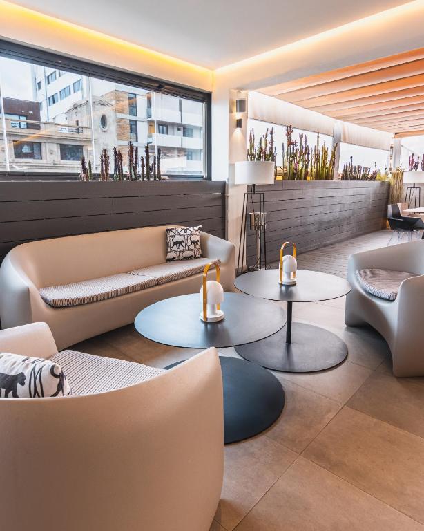 a lobby with couches and tables in a building at Hotel Adonis Plaza in Santa Cruz de Tenerife