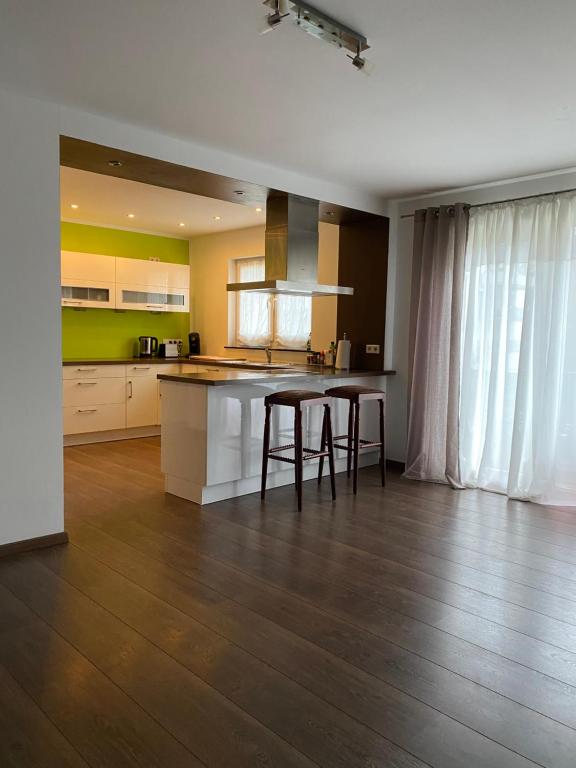 a kitchen with a table and two stools at Julias Ferienwohnung in Wetzlar
