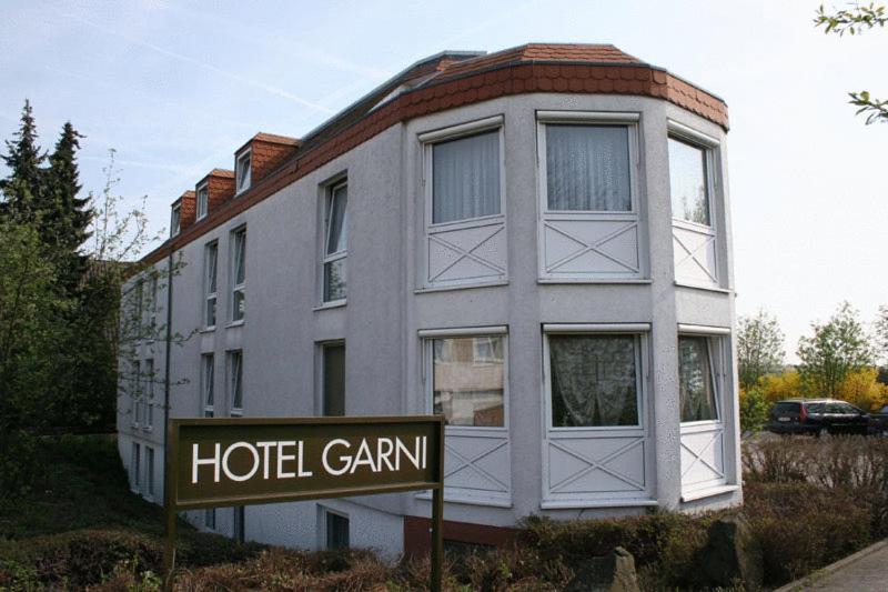 ein Hotelcamann-Gebäude mit einem Schild davor in der Unterkunft Hotel Garni in Rosbach vor der Höhe