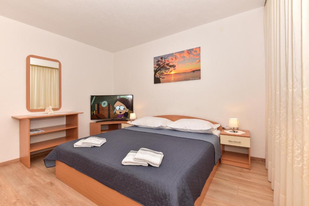 Postel nebo postele na pokoji v ubytování Apartments Vjeko