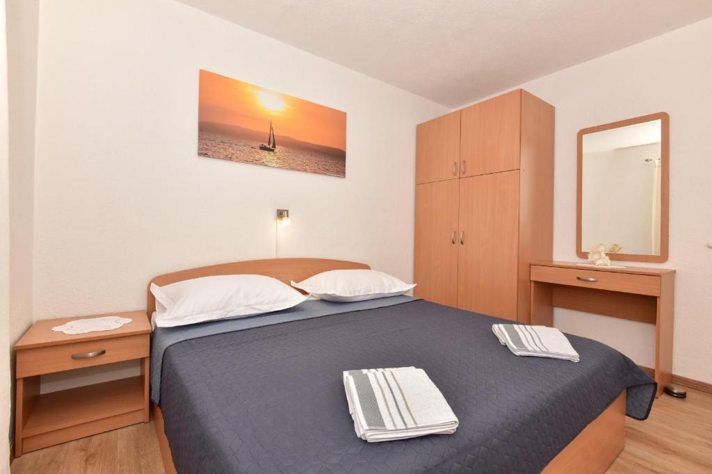 Postel nebo postele na pokoji v ubytování Apartments Vjeko