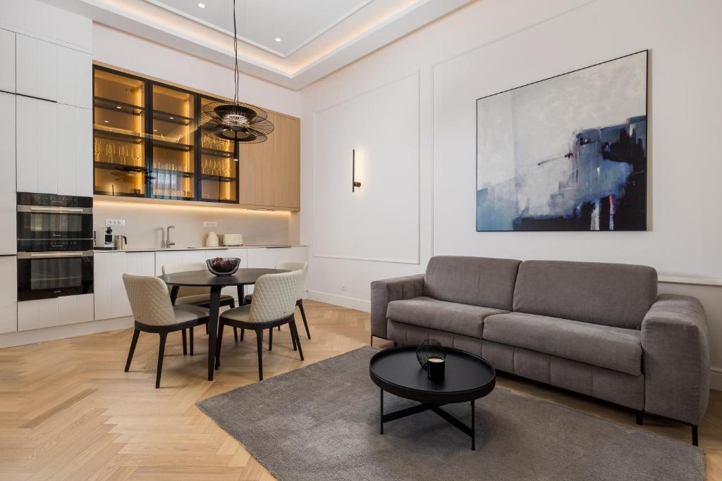a living room with a couch and a table at Plaza Apartments in Opatija