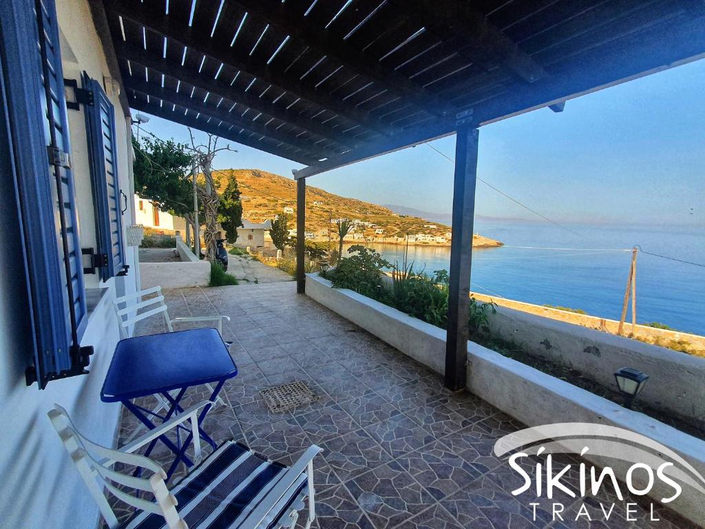 a patio with chairs and a view of the ocean at Alopronoia Sunrise in Sikinos