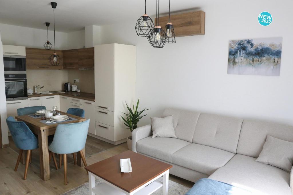 a living room with a couch and a table at St.Gotthard Apartman in Szentgotthárd