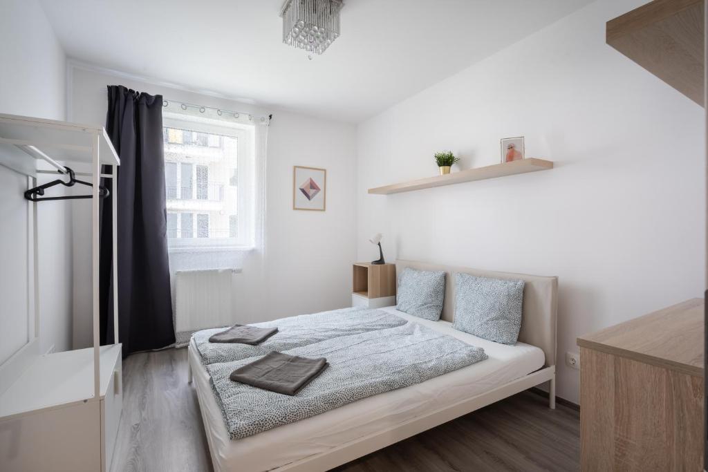 Posteľ alebo postele v izbe v ubytovaní Szabolcs Apartments