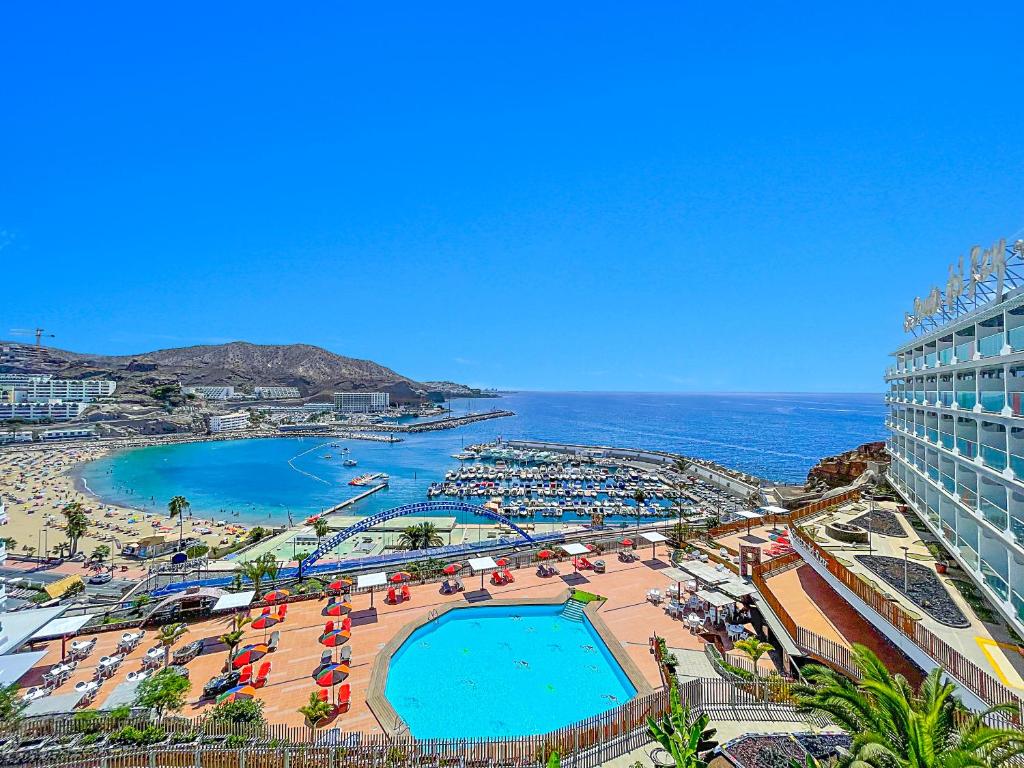 a view of a resort with a pool and a beach at Punta Del Rey Only Adults in Puerto Rico de Gran Canaria