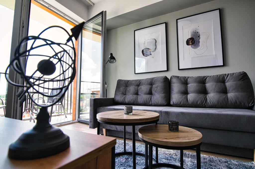 salon z kanapą i dwoma stołami w obiekcie Apartament Timi Zator by Housine w Zatorze