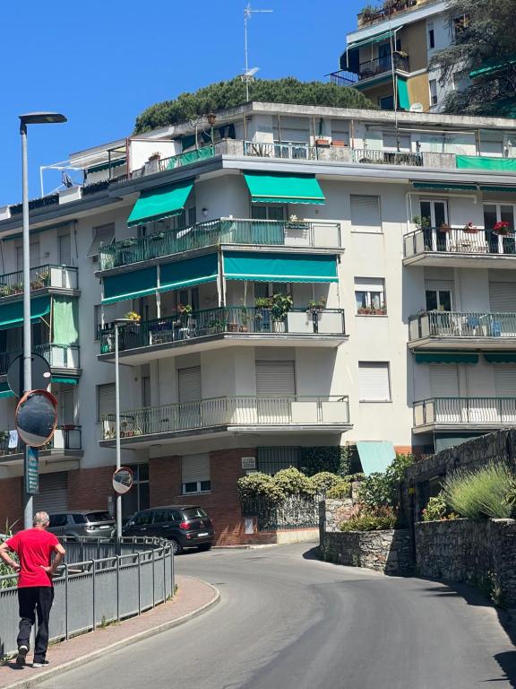 a man riding a skateboard down a street in front of a building at OUR HOME in Rapallo