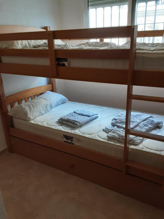 a couple of bunk beds in a room at BRISAS DEL MAR II in Formentera del Segura