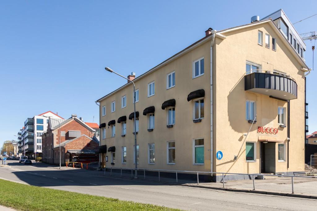 a building on the side of a street at Bucco Suites in Pori