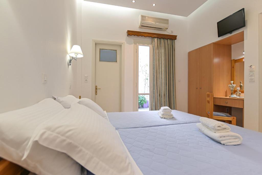 Postel nebo postele na pokoji v ubytování Hotel Zeus