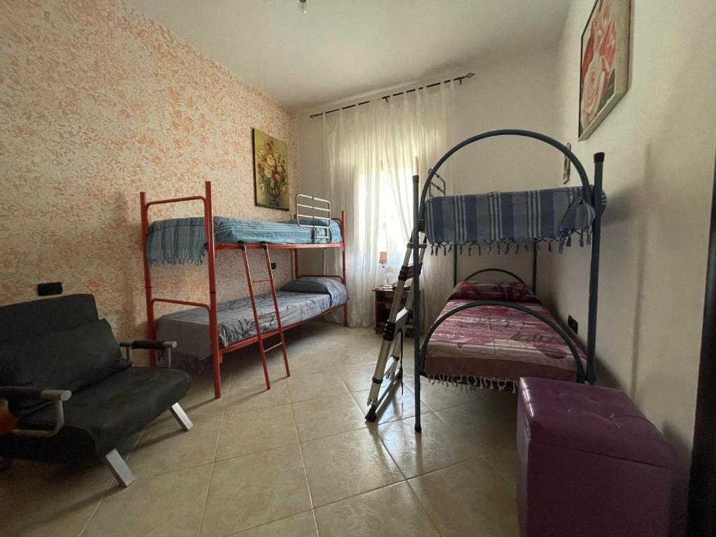 A bed or beds in a room at La casa di Dedda I.U.N. Q4233