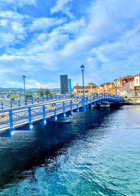 a blue bridge over the water with buildings in the background at Les Bruyères in Martigues