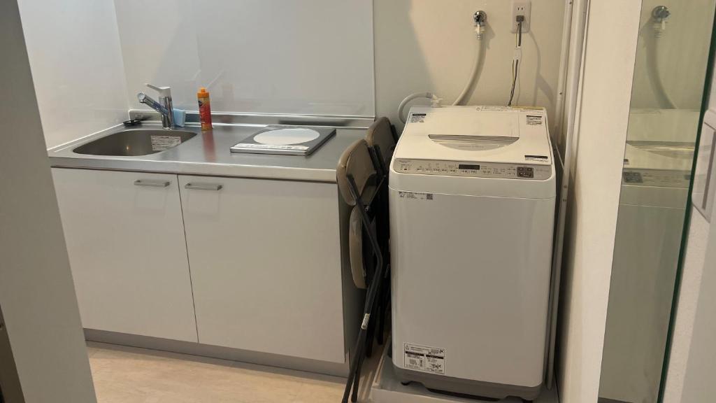 Kuchyň nebo kuchyňský kout v ubytování Living Inn Nahakoumae