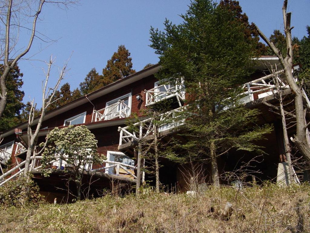 a house with balconies on the side of it at Pension Logette Sanbois in Nikko