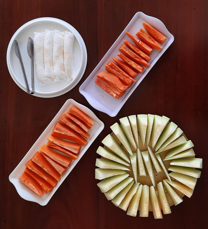 a table with plates of carrots and a plate of cheese at Pousada Brilho dos Lençóis in Barreirinhas