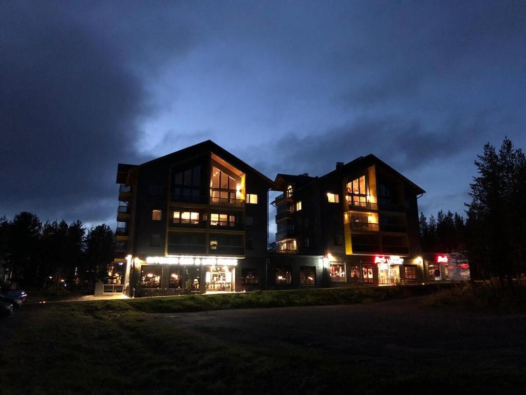 a large building at night with lights at Levin Kunkku B9 in Sirkka