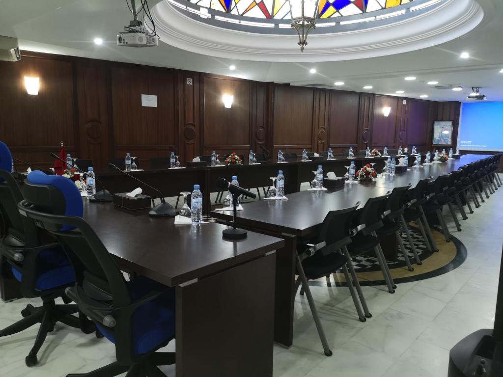a meeting room with a long table and chairs at Majliss Hotel Downtown in Rabat