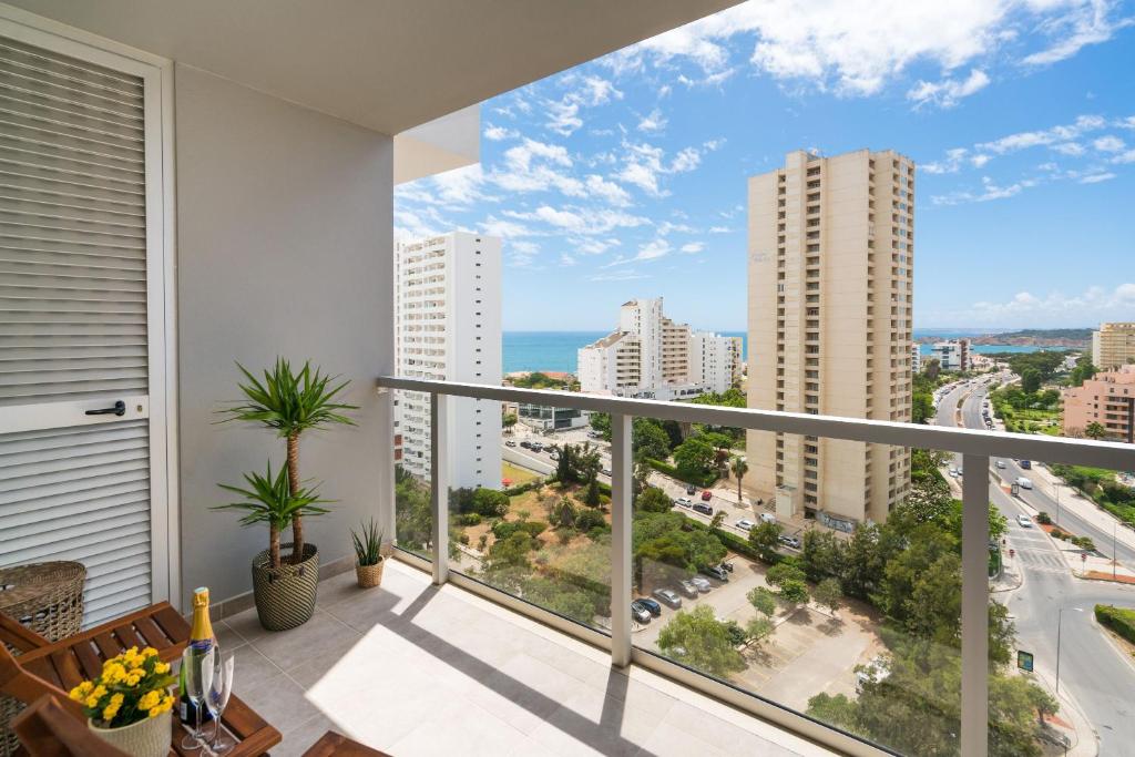 a balcony with a view of the ocean and buildings at Casa Keronen - Elite Residence in Portimão
