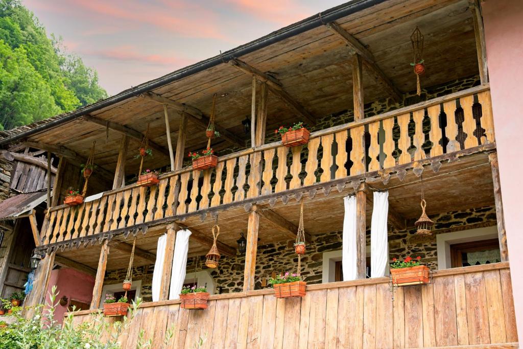 a building with a balcony with potted plants on it at Adelaide House by casa Shanty in Calasca Castiglione