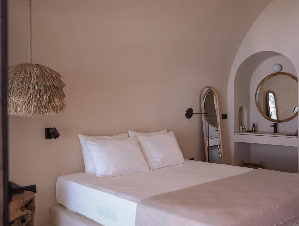 a bedroom with a white bed and a mirror at GAIA Alaçatı BY THE SEA - Adult Only in Çeşme