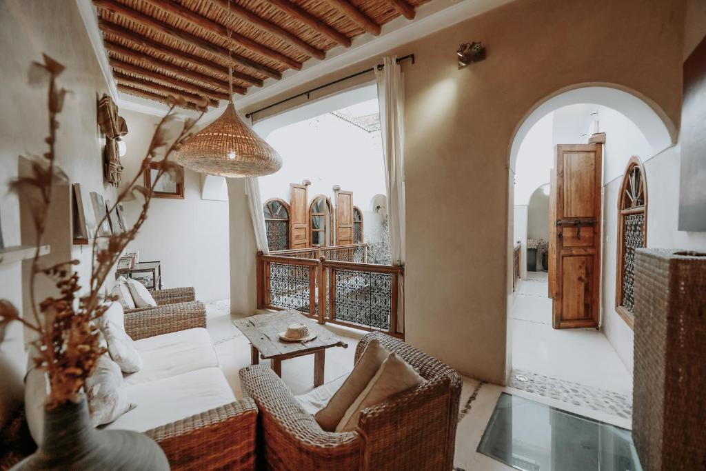 a living room with a couch and a table at Dar Nour el Houda in Marrakesh