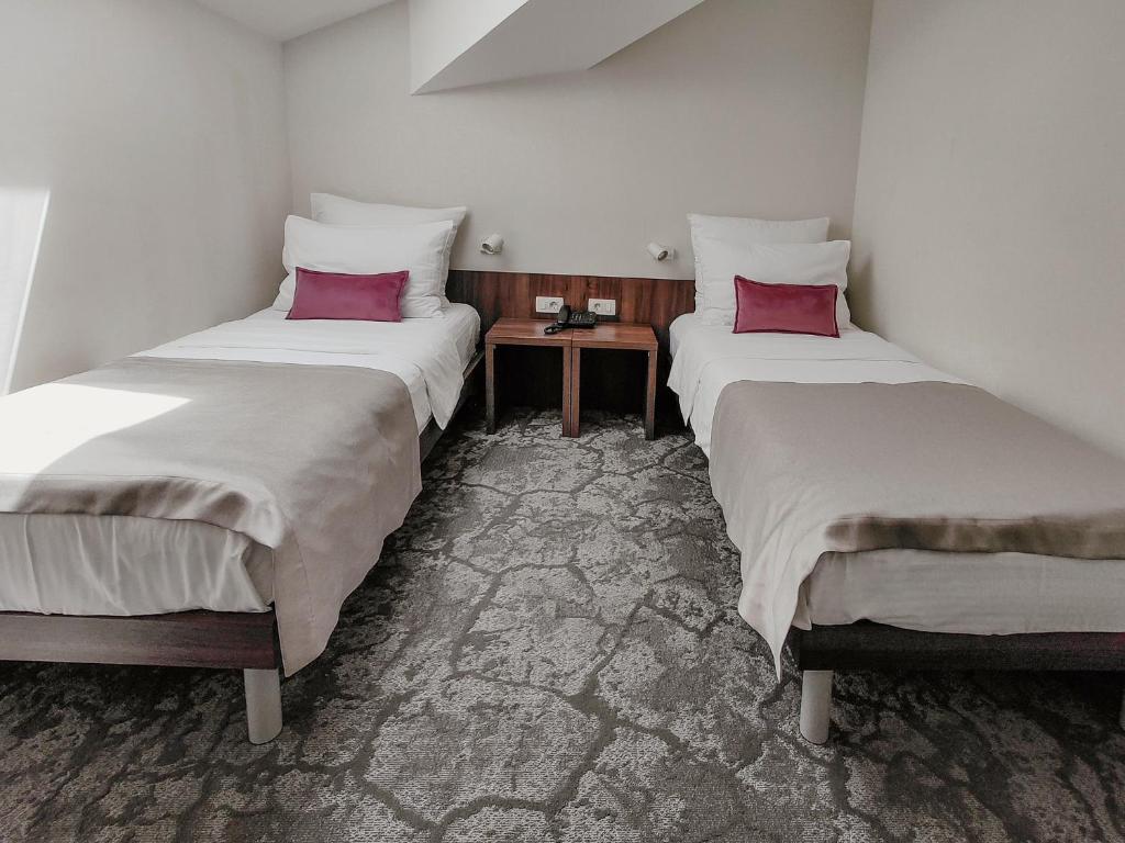 Postel nebo postele na pokoji v ubytování Hotel Pine