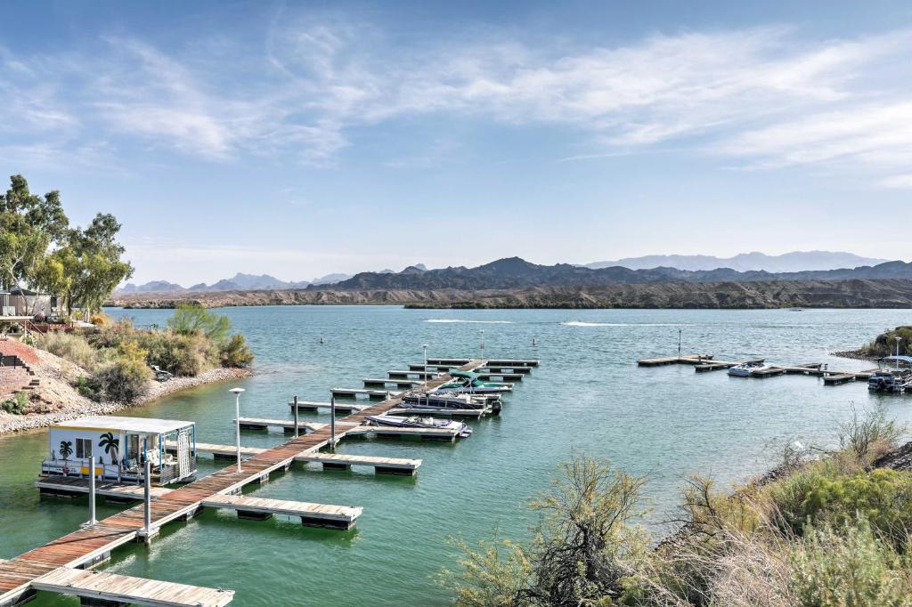 a group of boats parked at a dock on a river at Dock and Beach Access Cozy Lake Havasu City Home! in Lake Havasu City
